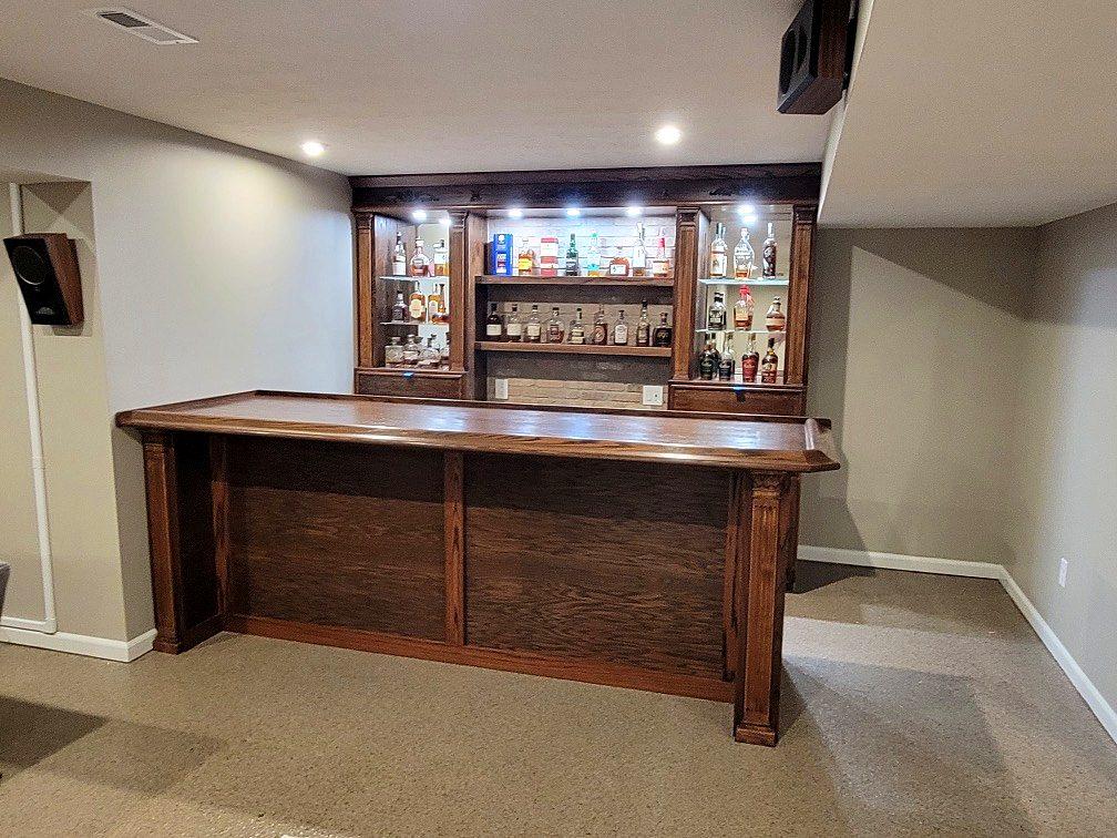Finished basement with custom wood bar, lighted back bar and new carpet