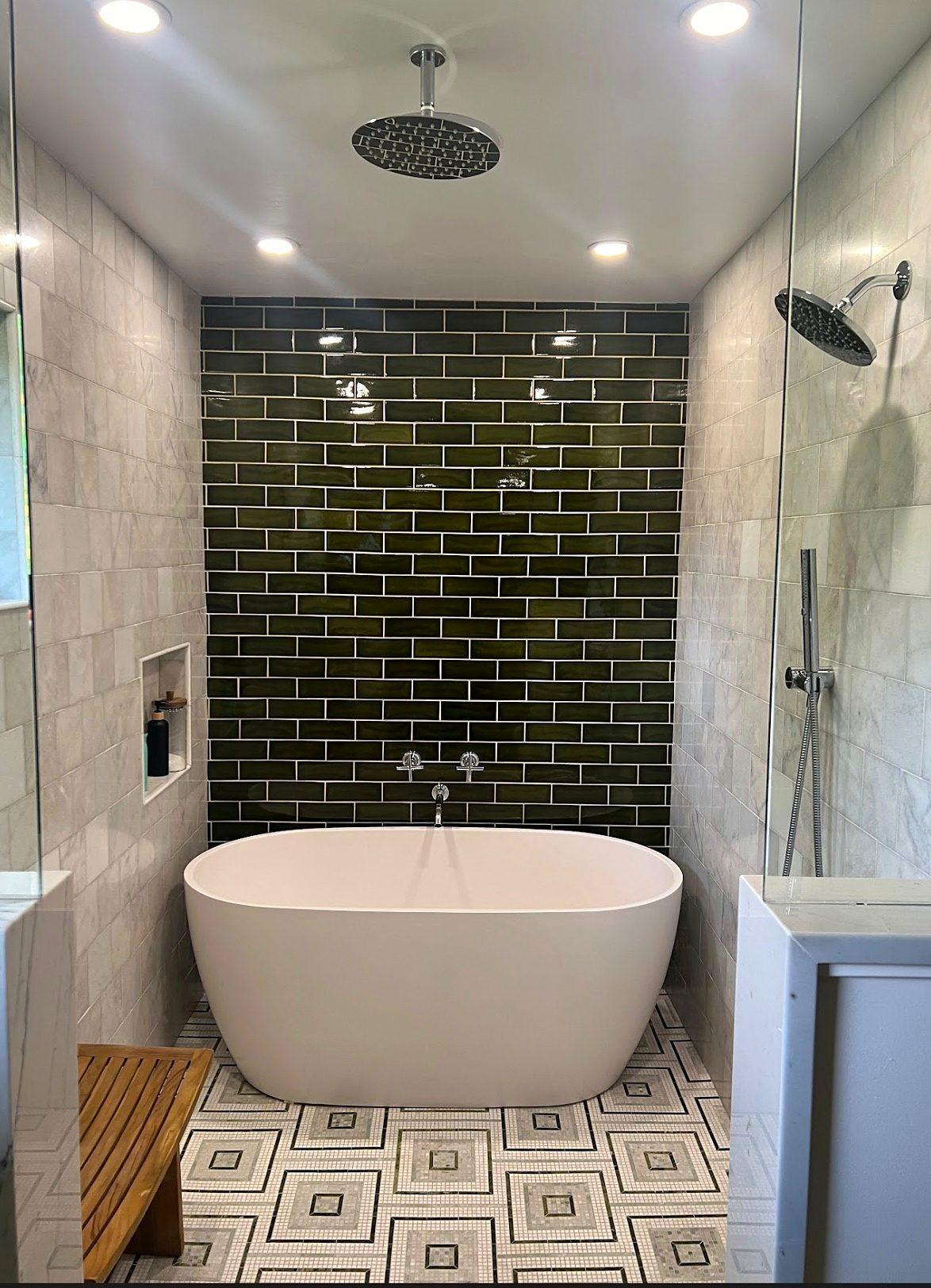 Luxury bathroom remodel with freestanding soaking tub, rain shower wet room, green subway tile and geometric floor tile