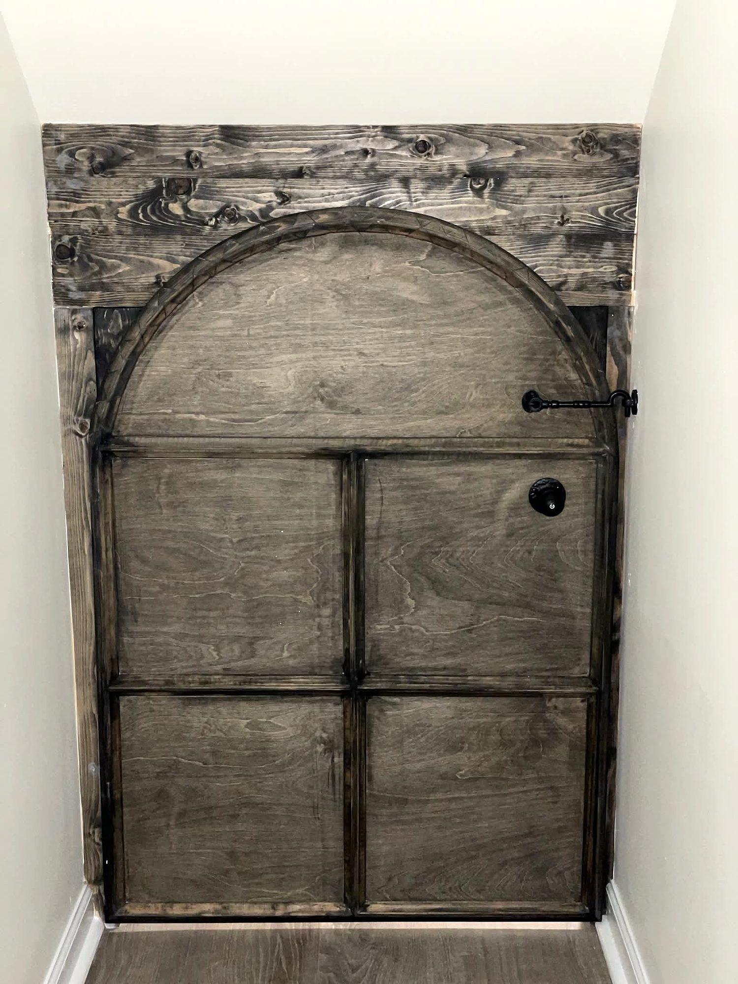 Custom arched rustic wood door with iron strap hardware