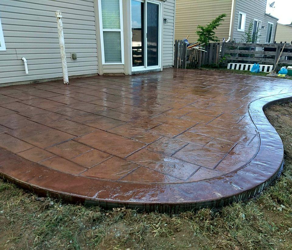 Curved stamped concrete patio with ashlar-slate pattern and contrasting border