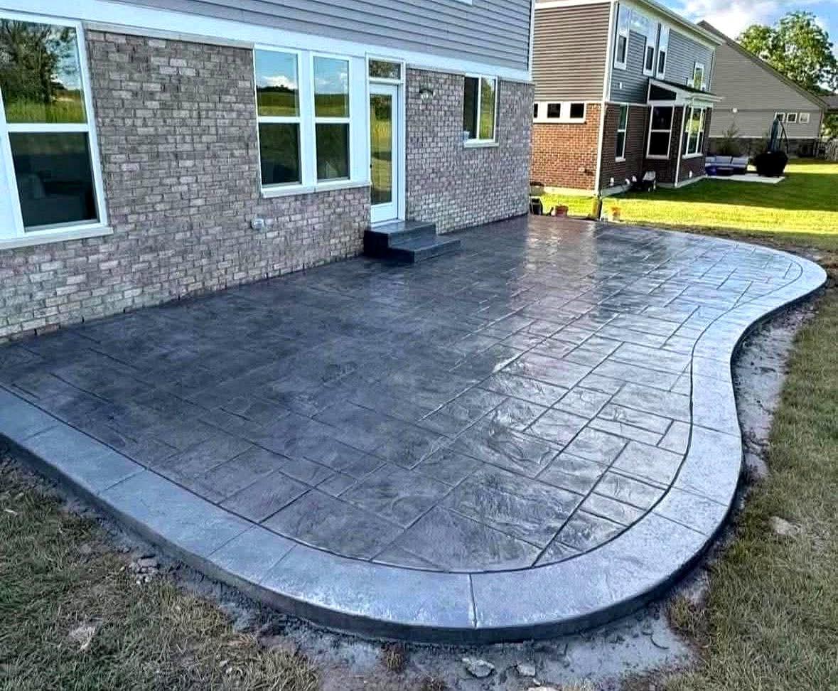 Gray stamped concrete patio with curved border